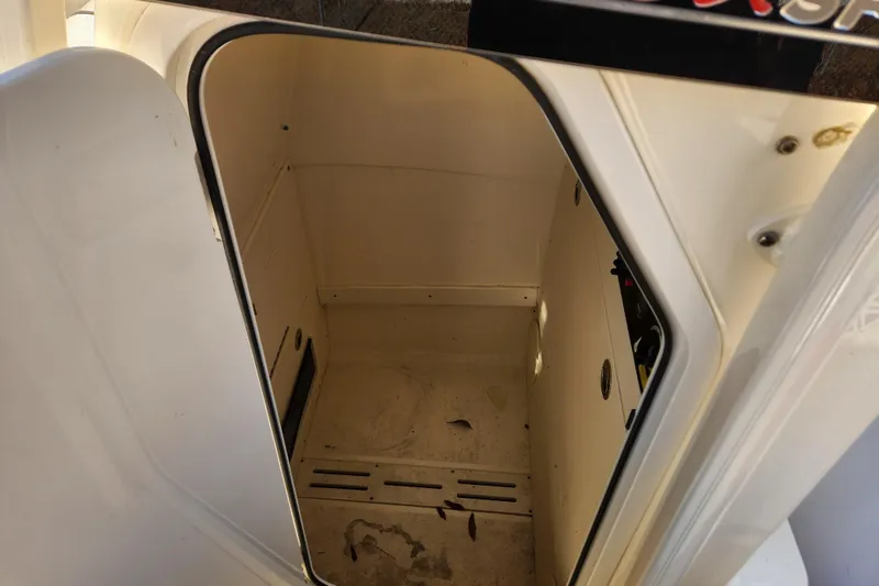 Slide: The Image of 2024 Scout 215 XSF storage compartment with open door, showcasing interior space. - 24