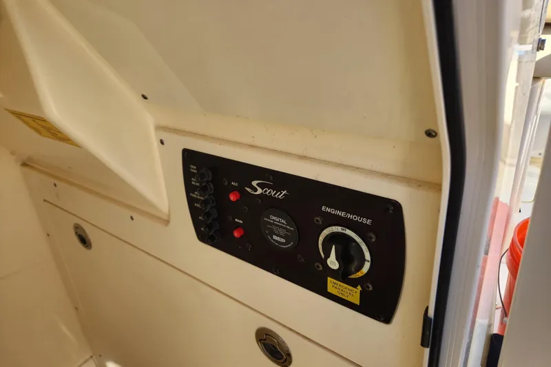 Slide: The Image of 2024 Scout 215 XSF boat control panel with switches and dials. - 25