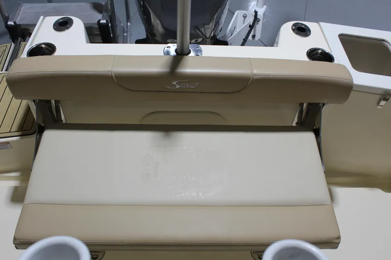 Slide: The Image of 2024 Scout 215 XSF boat seat with beige upholstery and cup holders. - 27