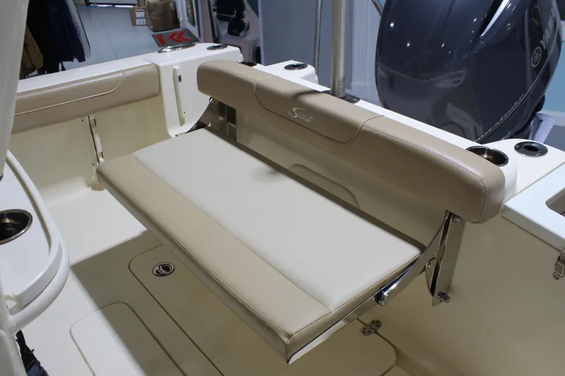 Slide: The Image of 2024 Scout 215 XSF boat interior with beige seating and cup holders. - 28