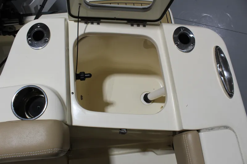 Slide: The Image of 2024 Scout 215 XSF boat interior with open storage compartment and cup holders. - 29