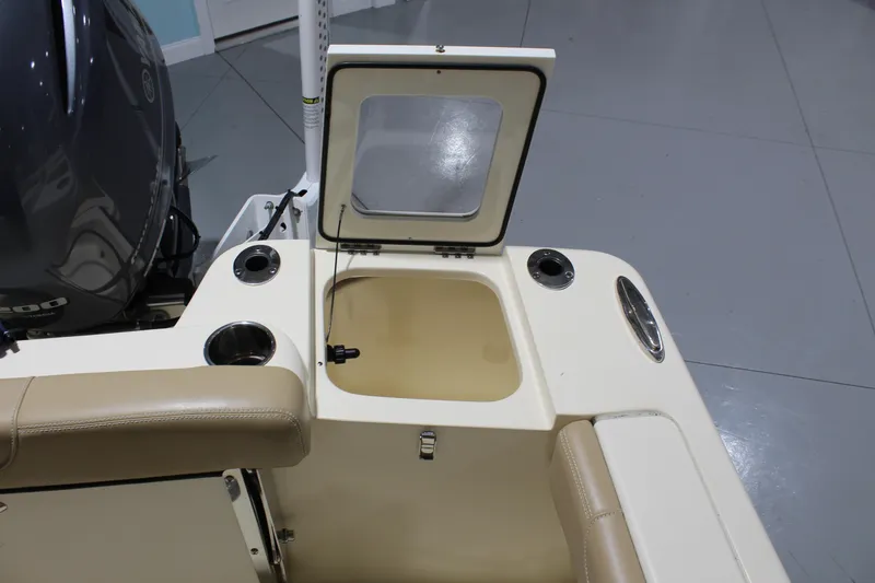 Slide: The Image of 2024 Scout 215 XSF boat interior with open storage compartment and cup holders. - 30