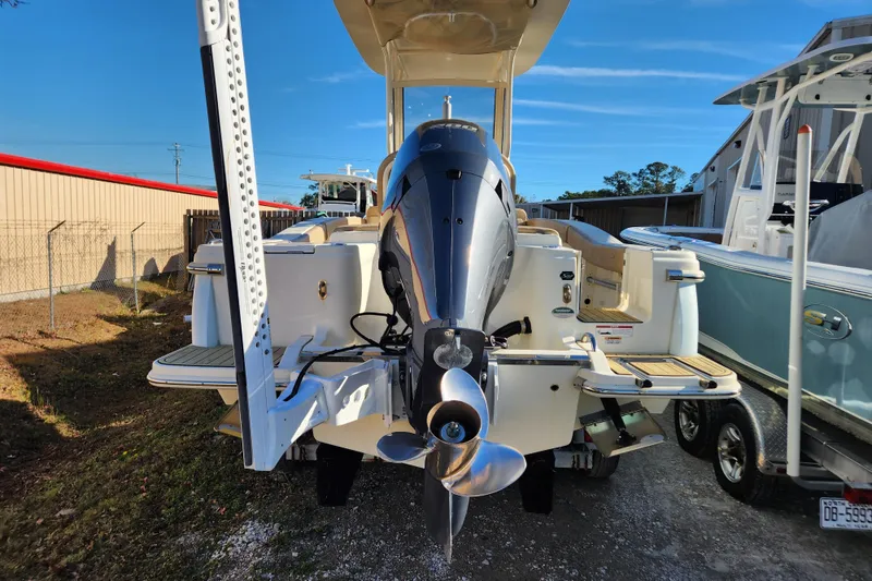 Slide: The Image of 2024 Scout 215 XSF boat displayed indoors on wheeled supports. - 4