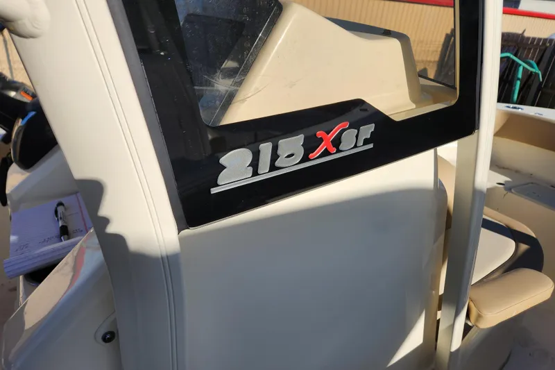 Slide: The Image of 2024 Scout 215 XSF boat with Yamaha outboard motor in showroom. - 6