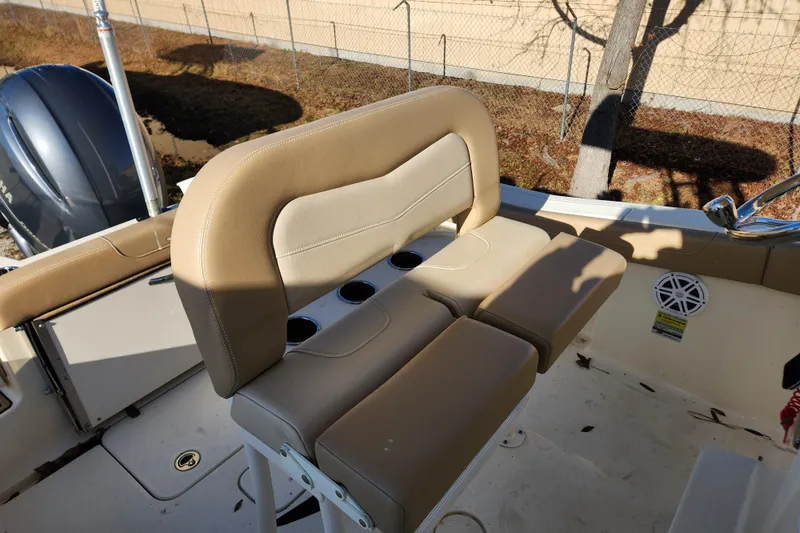 Slide: The Image of 2024 Scout 215 XSF boat interior with helm and T-top in showroom. - 8