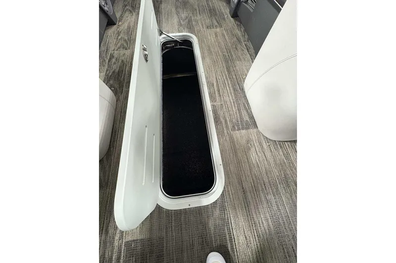 Slide: The Image of Open storage compartment on 2026 Avalon 2585 CAT QL boat, featuring sleek interior design. - 10