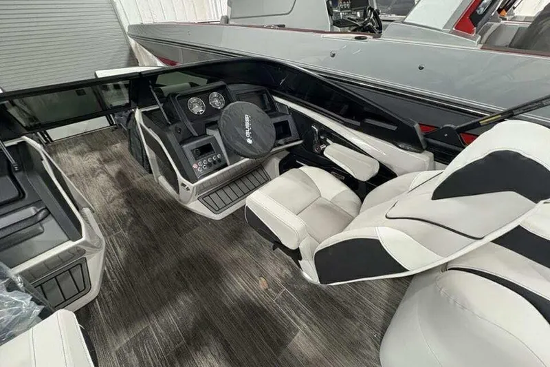 Slide: The Image of Interior of 2026 Avalon 2585 CAT QL boat with modern dashboard and seating. - 13