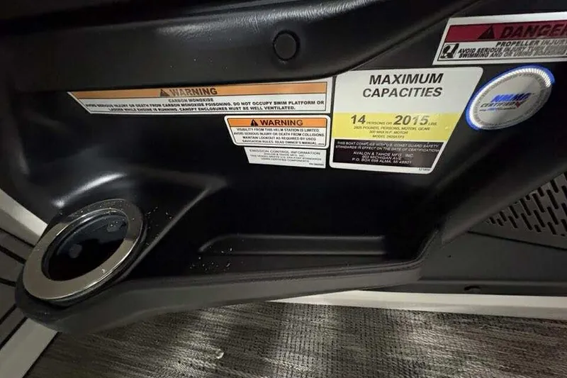 Slide: The Image of Interior view of 2026 Avalon 2585 CAT QL boat with capacity warnings and cup holder. - 14