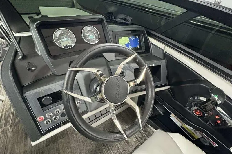 Slide: The Image of Steering console of 2026 Avalon 2585 CAT QL boat with modern controls and navigation display. - 17