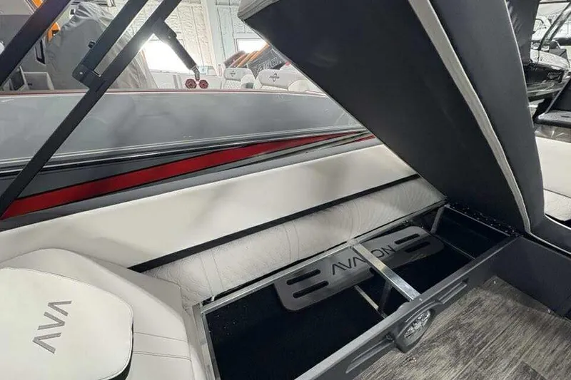 Slide: The Image of 2026 Avalon 2585 CAT QL boat interior with open storage compartment and sleek seating. - 18