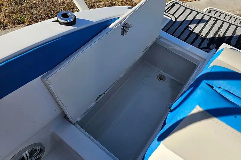 Slide: The Image of 2017 Starcraft Crossover 231 SCX OB boat storage compartment open, showing interior space. - 10