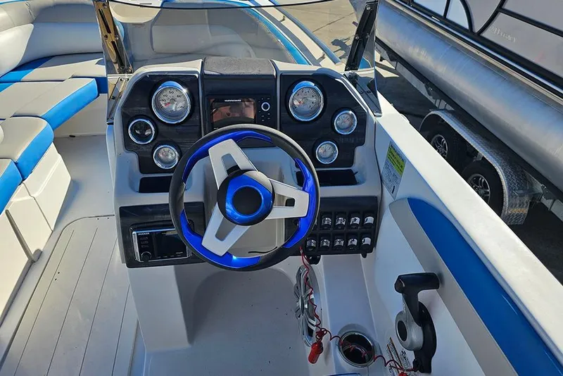 Slide: The Image of 2017 Starcraft Crossover 231 SCX OB boat dashboard with blue-accented steering wheel. - 12