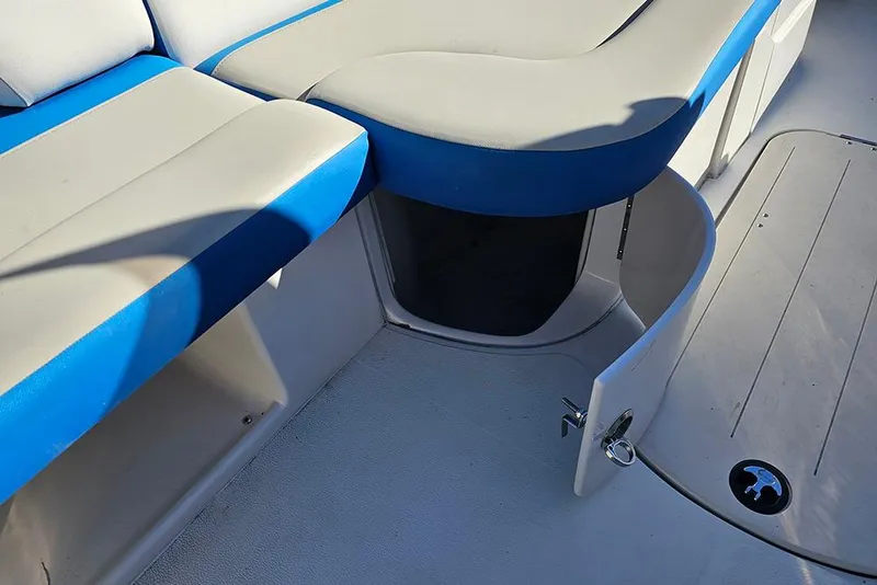 Slide: The Image of 2017 Starcraft Crossover 231 SCX OB boat interior with blue and gray seating. - 15