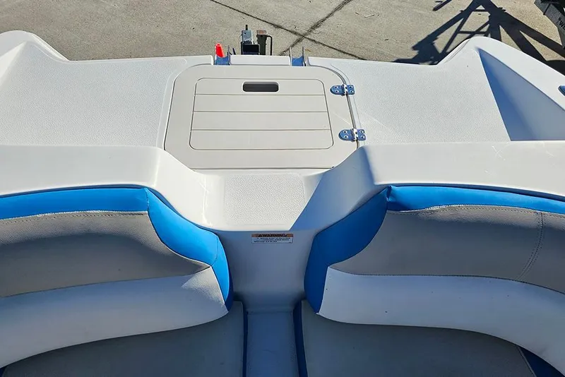 Slide: The Image of 2017 Starcraft Crossover 231 SCX OB boat interior with blue and white seating. - 16