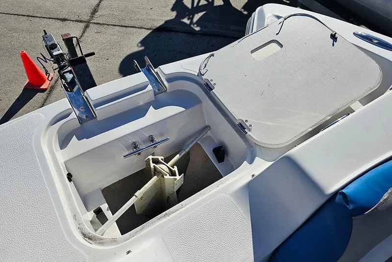 Slide: The Image of 2017 Starcraft Crossover 231 SCX OB boat anchor compartment with open hatch. - 17