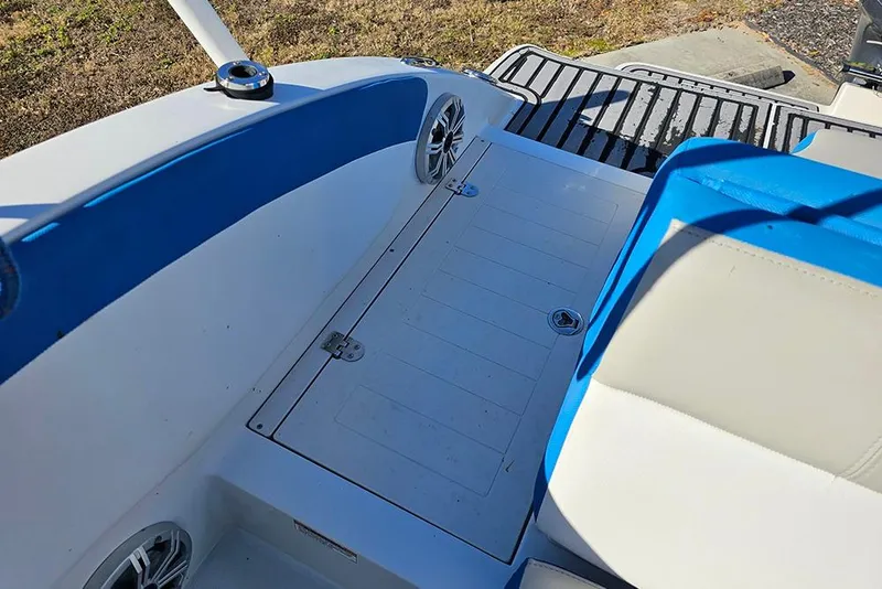 Slide: The Image of 2017 Starcraft Crossover 231 SCX OB boat interior with blue and white seating. - 9