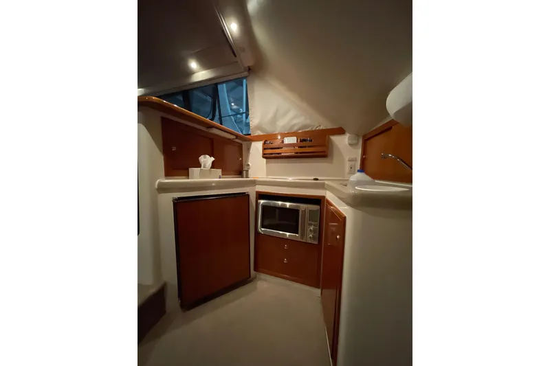 Slide: The Image of Interior of 2002 Riviera 34 Convertible yacht with nautical decor and marina view. - 12
