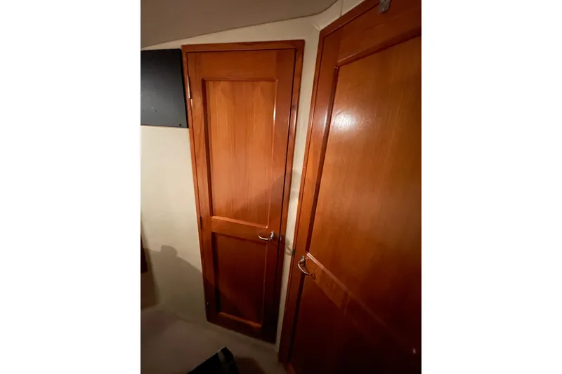 Slide: The Image of Interior of 2002 Riviera 34 Convertible yacht kitchen with modern appliances and wood cabinetry. - 15