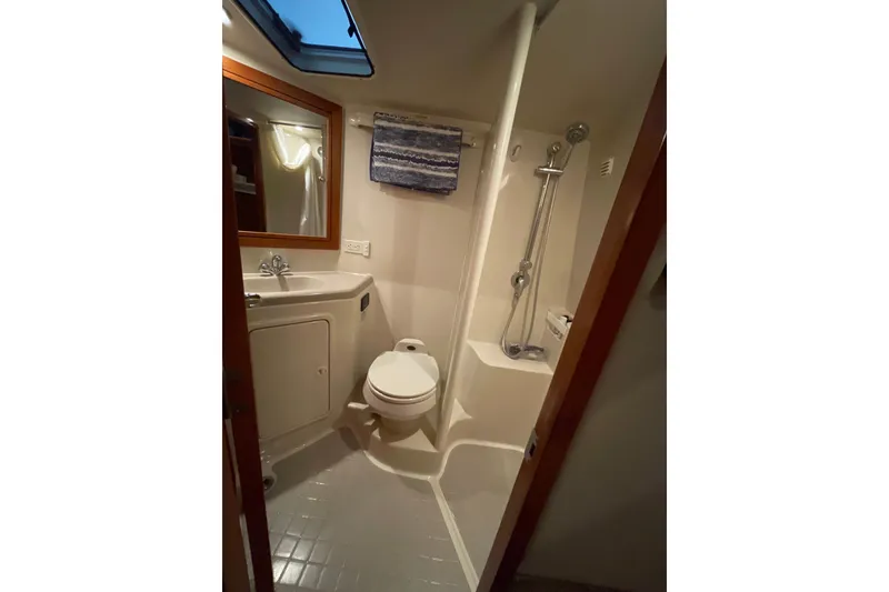 Slide: The Image of Interior cabin of 2002 Riviera 34 Convertible yacht, featuring wood paneling and cozy lighting. - 19