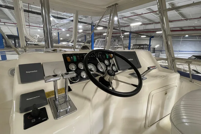 Slide: The Image of Storage compartment inside 2002 Riviera 34 Convertible boat, featuring hydraulic struts. - 21