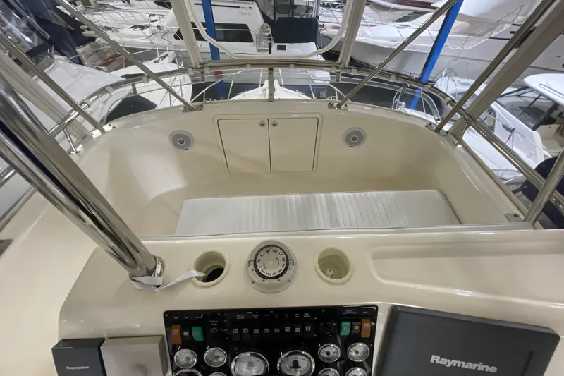 Slide: The Image of Captain's chairs on 2002 Riviera 34 Convertible yacht, featuring sleek white upholstery. - 24