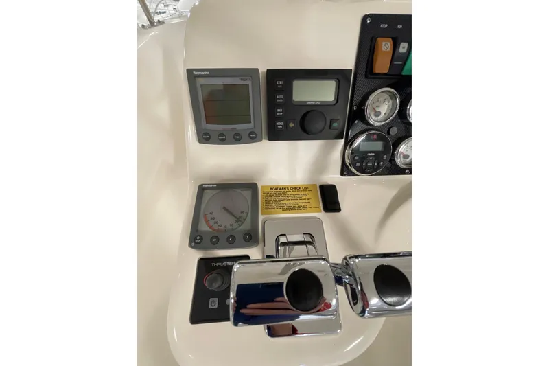 Slide: The Image of 2002 Riviera 34 Convertible boat interior with white seating and storage compartment. - 25