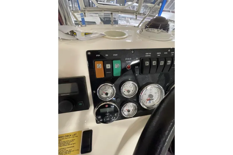 Slide: The Image of Cockpit view of 2002 Riviera 34 Convertible yacht with navigation controls. - 26