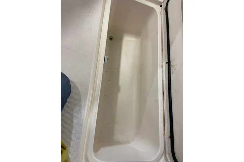 Slide: The Image of Interior view of 2002 Riviera 34 Convertible boat, featuring hooks and a blue cloth. - 34