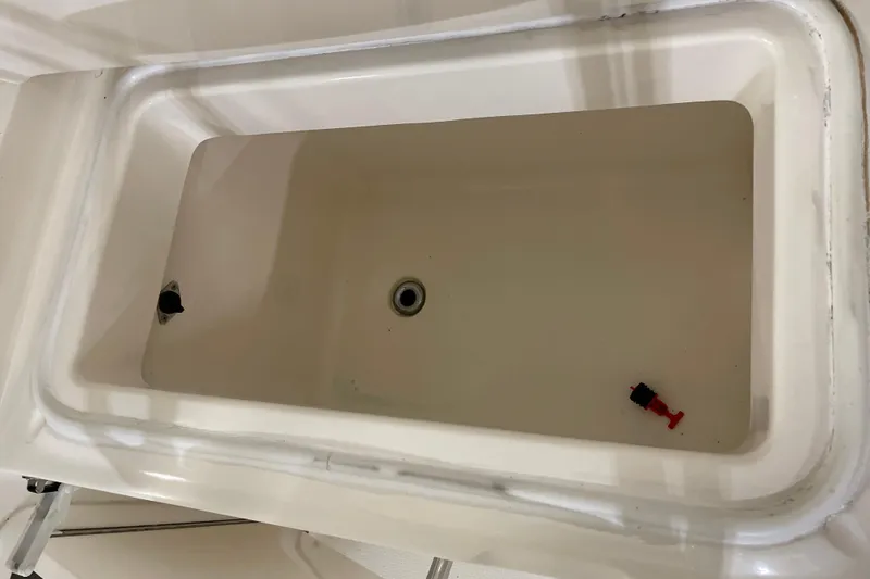 Slide: The Image of Storage compartment on a 2002 Riviera 34 Convertible boat, open and empty. - 35