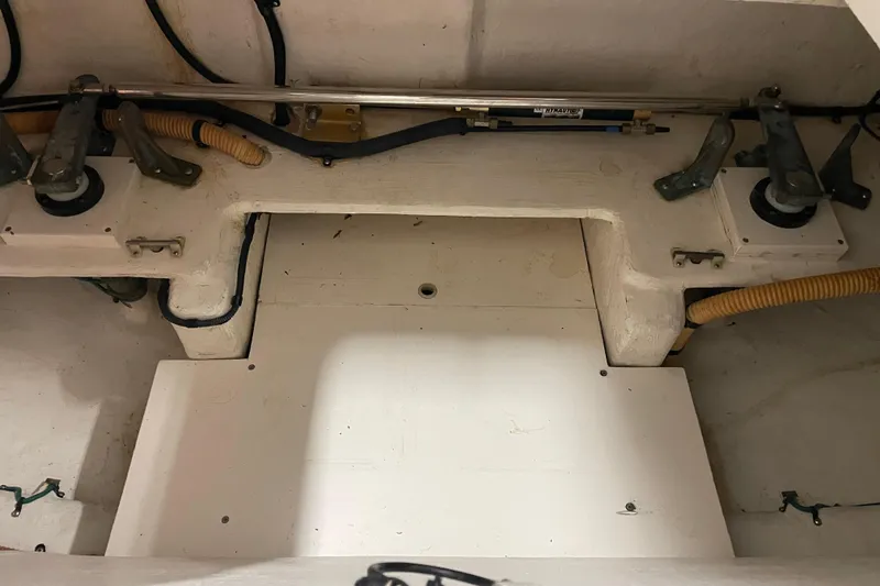 Slide: The Image of 2002 Riviera 34 Convertible boat interior compartment with drain plug. - 36