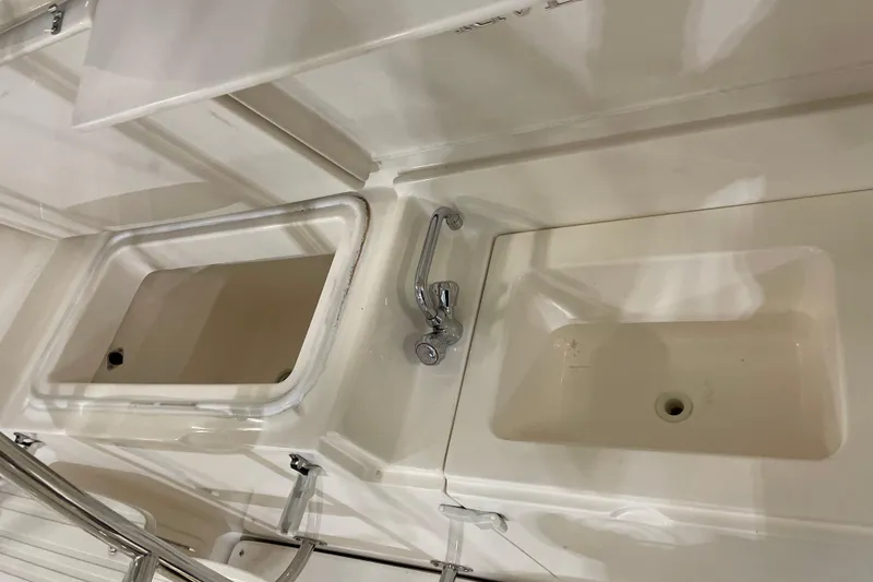 Slide: The Image of Storage compartment with buoys and rope on a 2002 Riviera 34 Convertible boat. - 38