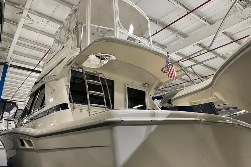 Slide: The Image of Interior of 2002 Riviera 34 Convertible yacht with cozy seating and modern amenities. - 4