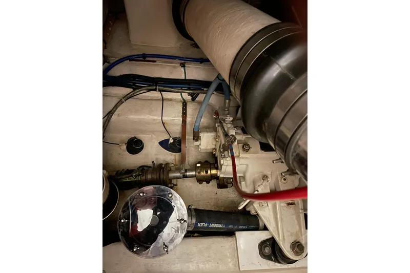 Slide: The Image of Engine compartment of 2002 Riviera 34 Convertible boat, showing mechanical components and wiring. - 44