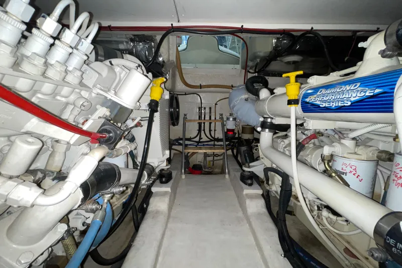 Slide: The Image of Engine room of a 2002 Riviera 34 Convertible boat, showcasing mechanical components. - 46