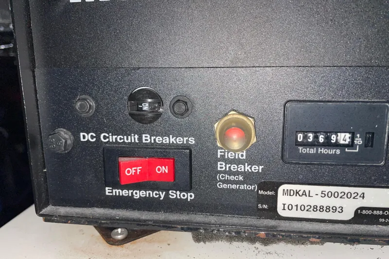 Slide: The Image of Control panel of a 2002 Riviera 34 Convertible with circuit breakers and hour meter. - 50