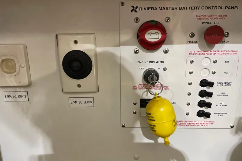 Slide: The Image of Control panel of a 2002 Riviera 34 Convertible boat with switches and labels. - 51