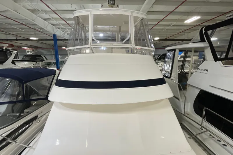 Slide: The Image of 2002 Riviera 34 Convertible yacht in indoor storage, surrounded by other boats. - 55