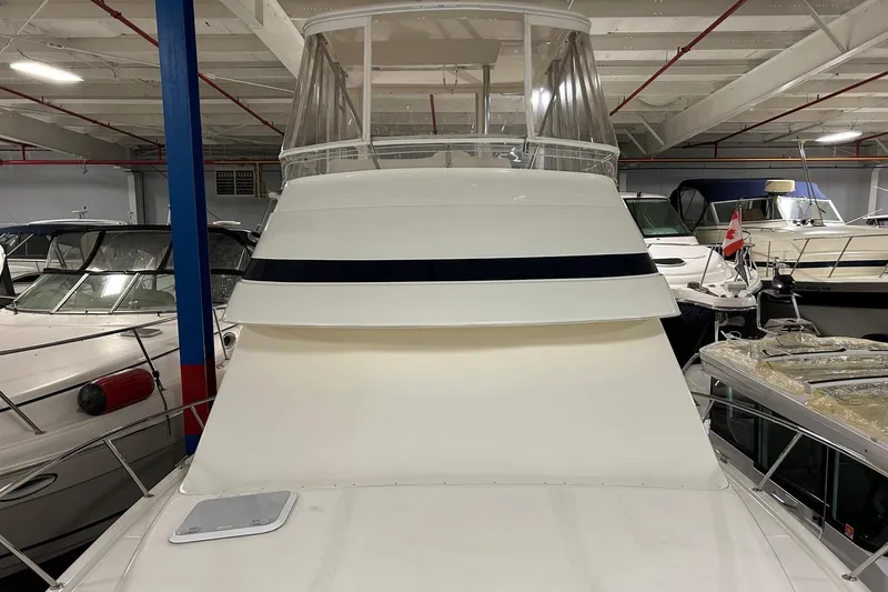 Slide: The Image of 2002 Riviera 34 Convertible yacht in indoor storage, surrounded by other boats. - 57