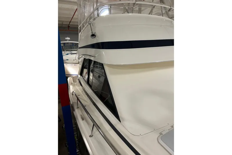 Slide: The Image of 2002 Riviera 34 Convertible yacht in a showroom, showcasing sleek design and structure. - 59