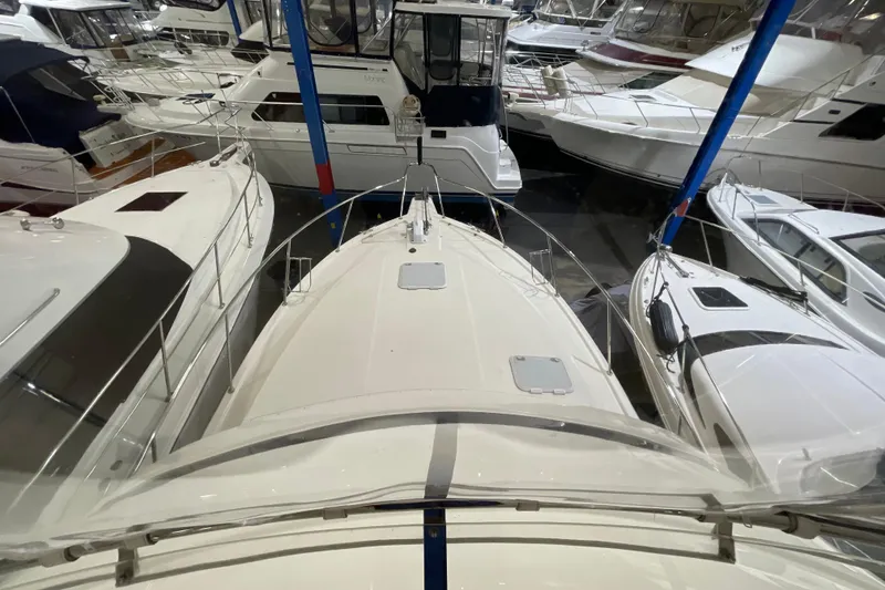 Slide: The Image of 2002 Riviera 34 Convertible yacht in a marina, surrounded by other boats. - 61