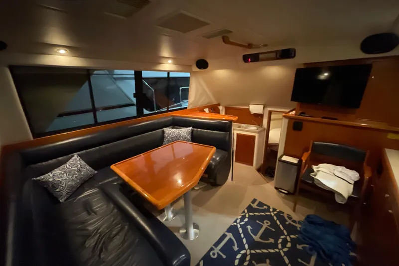 Slide: The Image of 2002 Riviera 34 Convertible yacht in indoor storage, featuring sleek design and American flag. - 8