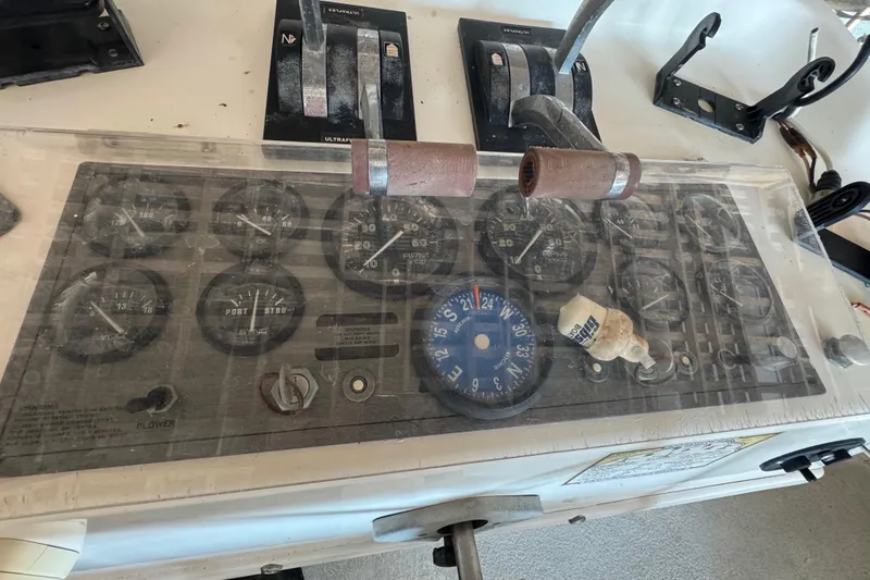 Slide: The Image of Control panel of a 1999 Gibson Houseboat 50 with gauges and levers. - 15