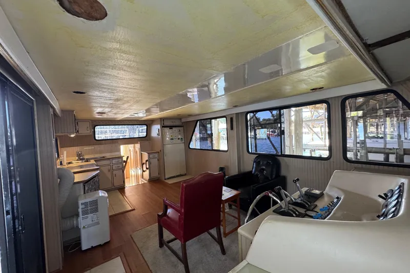 Slide: The Image of Interior of a 1999 Gibson Houseboat 50 with kitchen and seating area. - 16