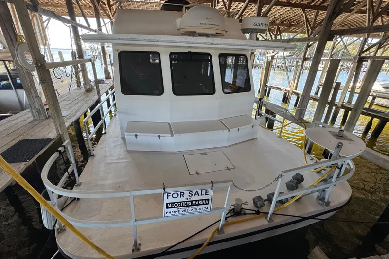 Slide: The Image of 1999 Gibson Houseboat 50 for sale at marina dock, featuring spacious deck. - 2