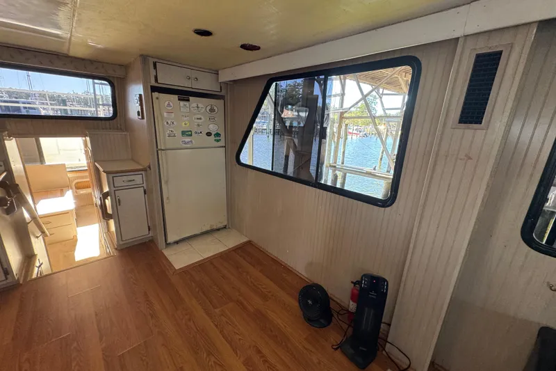 Slide: The Image of Interior of 1999 Gibson Houseboat 50 with wood flooring and large windows. - 20