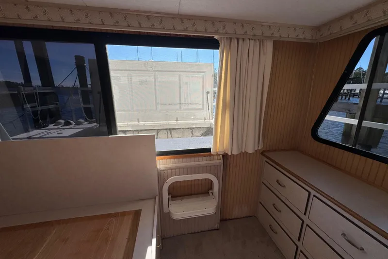 Slide: The Image of Interior of 1999 Gibson Houseboat 50 with wood paneling and large windows. - 25