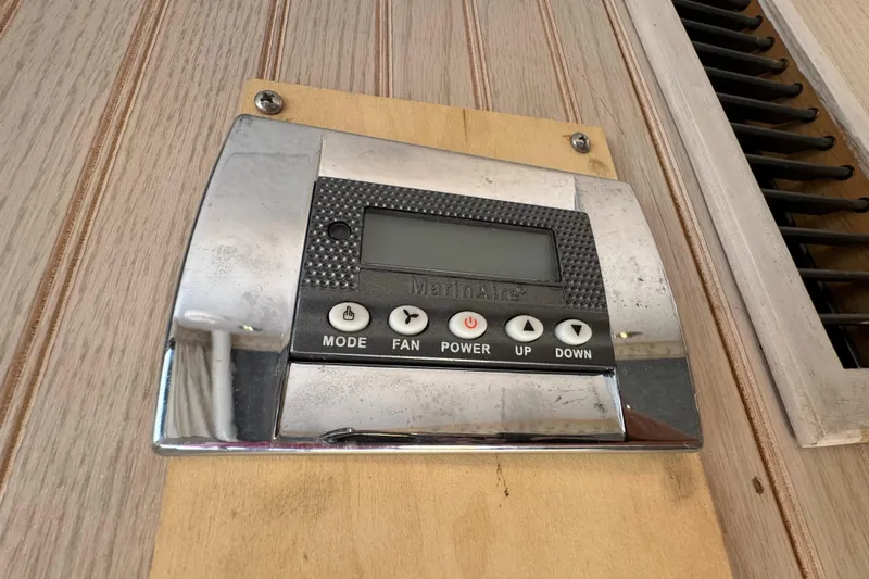 Slide: The Image of Control panel on 1999 Gibson Houseboat 50, featuring mode, fan, power, up, and down buttons. - 27