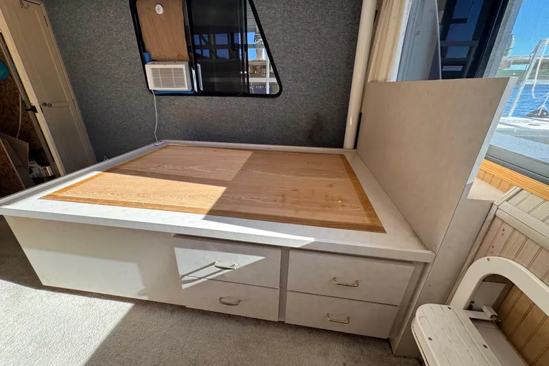 Slide: The Image of Interior of 1999 Gibson Houseboat 50 with bed and storage drawers. - 28