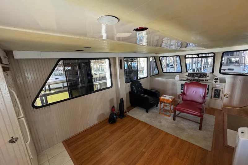 Slide: The Image of Interior of a 1999 Gibson Houseboat 50 with seating and control panel. - 38