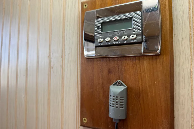Slide: The Image of Thermostat control panel on 1999 Gibson Houseboat 50 wooden interior wall. - 53